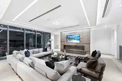 a living room with couches and a fireplace at Park Place Mansion in Fort Lauderdale