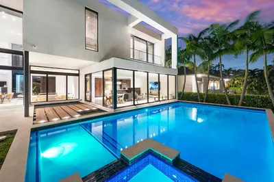 a large swimming pool in front of a house at Exquisite Modern Marvel in Golden Isles