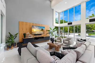 a living room with a large couch and a tv at Modani Estates in Miami