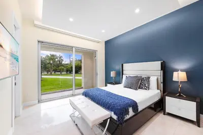 a bedroom with a bed and a large window at Modani Estates in Miami