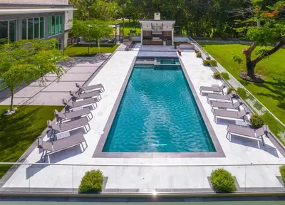 an overhead view of a swimming pool with lounge chairs and sidx sidx sidx at Modani Estates in Miami