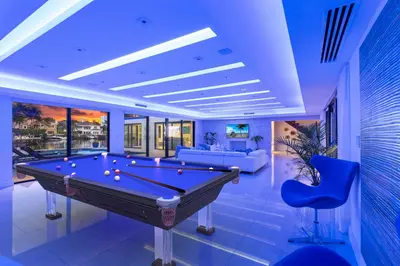 a pool table in a living room with blue lighting at Villa Paraiso in Hollywood