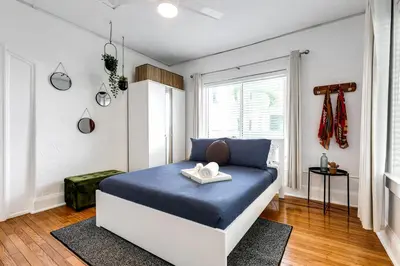 a bedroom with a bed with blue sheets and a window at Comfy Little Havana Apt - Centrally located Hv2 in Miami