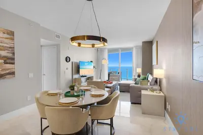 a dining room and living room with a table and chairs at Rooftop Oceanview Balcony Beachfront Resort in Hollywood