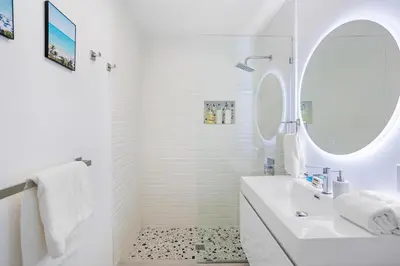 a white bathroom with a sink and a mirror at Coco Loco - Little Havana in Miami