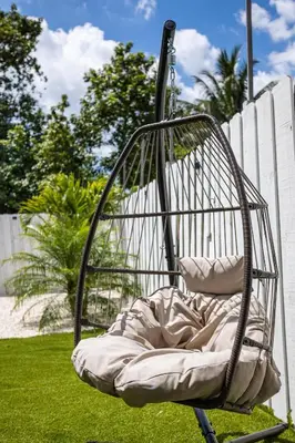 a swing chair sitting on the grass in a yard at Coco Loco - Little Havana in Miami