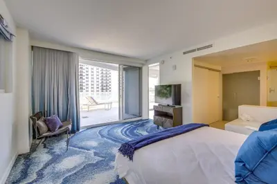 a bedroom with a large bed and a large window at Fort Lauderdale Condo with Veranda and Ocean View! in Fort Lauderdale