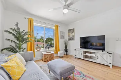 a living room with a couch and a tv at Comfy & Updated Apartment centrally located minutes away from everything! in Miami