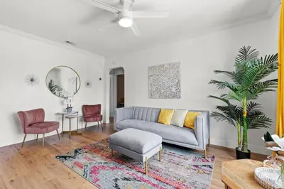 a living room with a couch and a mirror at Comfy & Updated Apartment centrally located minutes away from everything! in Miami