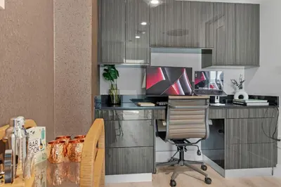 a kitchen with a desk with a computer and a chair at 2-Story 3BD Brickell Penthouse Free Parking Heated Pool in Miami