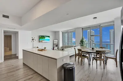a kitchen and dining room with a view of the ocean at Lower Penthouse 3BD 3BA - Beach Pool Gym in Hallandale Beach