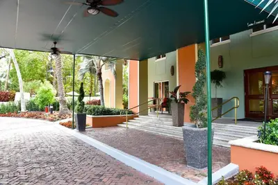 a building with a porch with stairs and plants at 1bed 1bath Steps To Marina & Cocowalk In Grove in Miami