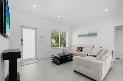 a white living room with a couch and a table at Villa Coco Cozy Home Near Brickell Miami Beach in Miami