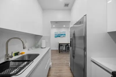 a kitchen with a sink and a refrigerator at Villa Mia Cozy Home in the heart of Miami in Miami