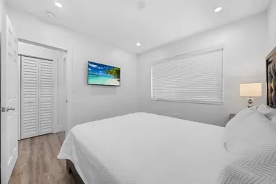 a white bedroom with a white bed and a window at Villa Mia Cozy Home in the heart of Miami in Miami