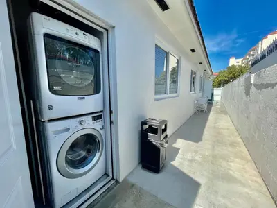 a washer and dryer sitting next to a building at Villa Mia Cozy Home in the heart of Miami in Miami