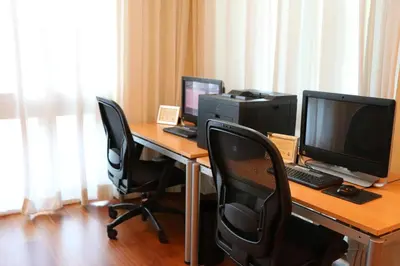 a desk with two monitors and a computer on it at Glamorous Bay View Studio In The Heart Of Grove in Miami