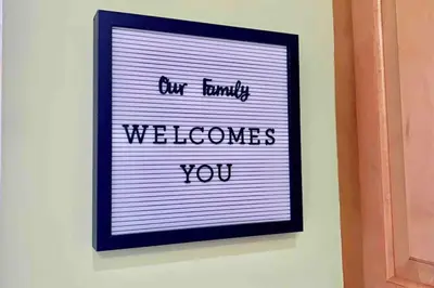 a sign that says our family welcomes you on a wall at Tropical Oasis home w Community Pool great area in Kendall