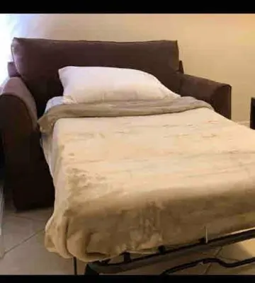 a bed with a blanket on top of it at Tropical Oasis home w Community Pool great area in Kendall