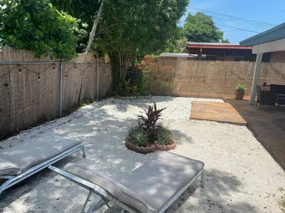 a patio with two benches and a fence at HOME AWAY FROM HOME Near Airport and Malls and Highways in South Miami