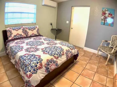 a bedroom with a bed and a chair at HOME AWAY FROM HOME Near Airport and Malls and Highways in South Miami