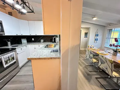 a kitchen with white cabinets and a counter top at Great location Pool home w Pool table 5br in Fort Lauderdale