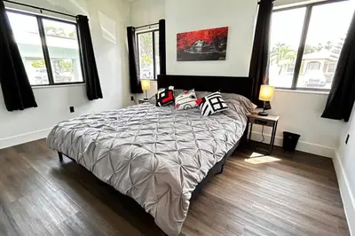 a bedroom with a large bed with pillows on it at Sunny Delight Home Near Airport in Hollywood