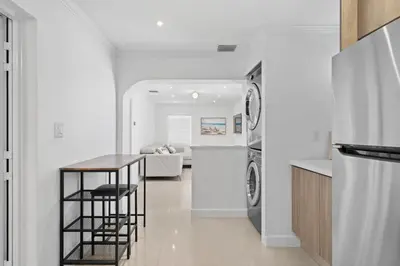 a kitchen and living room with a washer and dryer at Villa Capri Cottage in the heart of Miami in Miami