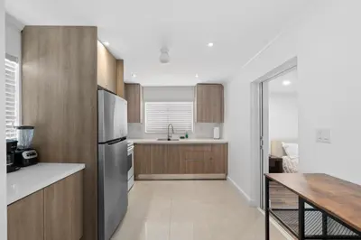 a kitchen with a refrigerator and a table at Villa Capri Cottage in the heart of Miami in Miami