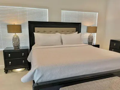 a bedroom with a large white bed with two night stands at Villa Gia Large Home Near Brickell Miami Beach in Miami