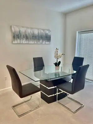a glass table with chairs and a potted plant on it at Villa Gia Large Home Near Brickell Miami Beach in Miami