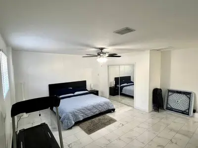 a bedroom with a bed and a ceiling fan at Sunny Getaway: Relaxing Miami Home in Tamiami