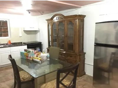 a kitchen with a table with chairs and a refrigerator at Miami House in Miami