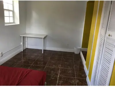 a room with a table and a tiled floor at Miami House in Miami