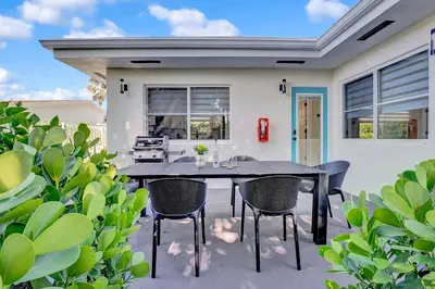 a patio with a black table and chairs at Oceana @ Casa Del Sol in Fort Lauderdale