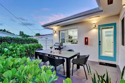 a patio with a table and chairs in front of a house at Oceana @ Casa Del Sol in Fort Lauderdale