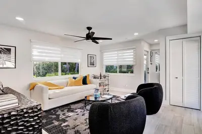 a living room with a couch and chairs and a ceiling fan at Oceana @ Casa Del Sol in Fort Lauderdale