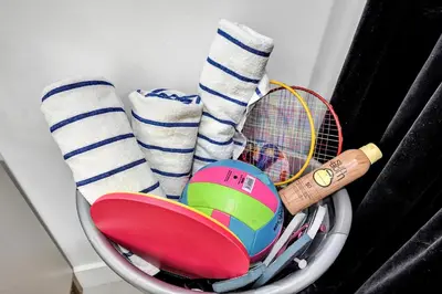 a basket with a tennis racket and socks at SOBE Monarch 1 - 2 BEDROOM 2 BATHROOM - MODERN APTS -WALK TO OCEAN DRIVE -2 INDEPENDENT 1 BEDROOM 1 BATHROOM APTS in Miami Beach