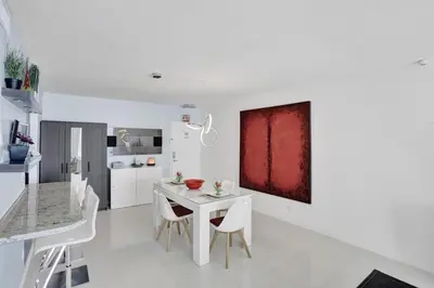a white kitchen with a white table and chairs at Beautiful 1 1 Beach View 14 Floor in Hollywood