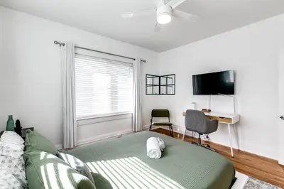a bedroom with a bed and a desk and a tv at Pleasing Little Havana Apt Fast WiFi Hv1 in Miami