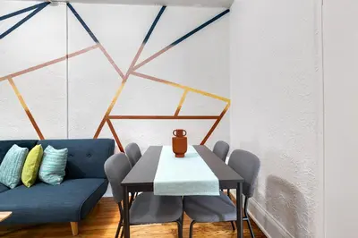 a dining room with a blue couch and a table and chairs at Pleasing Little Havana Apt Fast WiFi Hv1 in Miami