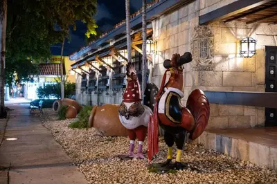 two roosters are standing in front of a building at Pleasing Little Havana Apt Fast WiFi Hv1 in Miami
