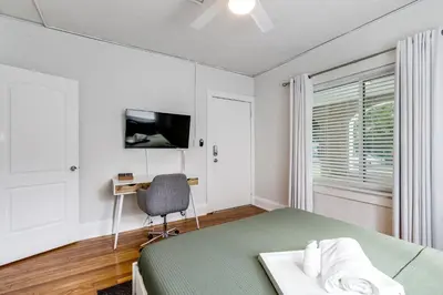 a bedroom with a bed and a desk and a television at Pleasing Little Havana Apt Fast WiFi Hv1 in Miami