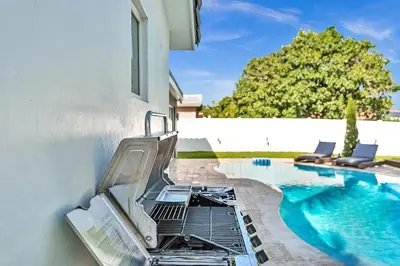 a swimming pool with a grill next to a house at Luxury Hollywood Home, Heated Pool, Casino Nearby in Hollywood