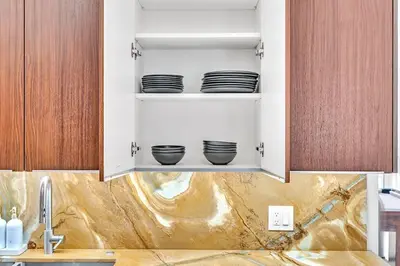 a kitchen with bowls on a shelf above a sink at Luxury Hollywood Home, Heated Pool, Casino Nearby in Hollywood