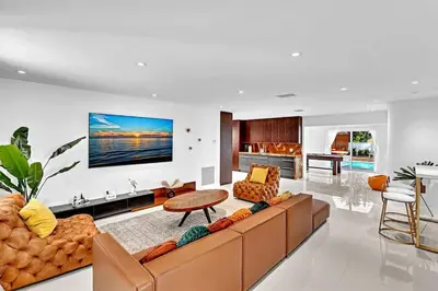 a living room with a couch and a table at Luxury Hollywood Home, Heated Pool, Casino Nearby in Hollywood