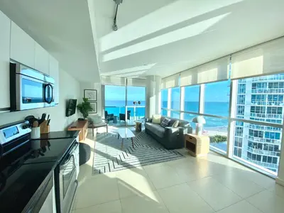 a large living room with a view of the ocean at Monte Carlo by Miami Ambassadors in Miami Beach