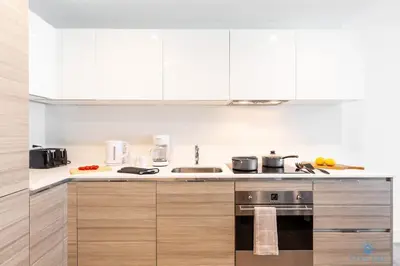 a kitchen with white cabinets and a stove top oven at Cozy Apartment - Hollywood Beach - Amazing Pool in Hollywood