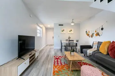 a living room with a couch and a tv at Loft style 1b Apt , Fast Wi-Fi Virg14 in Miami