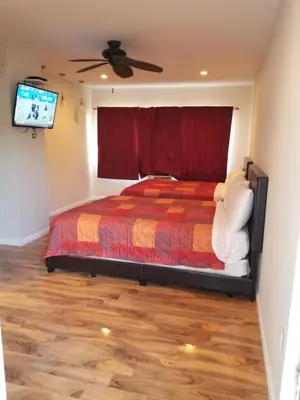 a bedroom with a bed and a flat screen tv at Royal Budget Inn in Miami